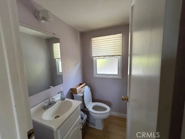 a view of kitchen with refrigerator and cabinets
