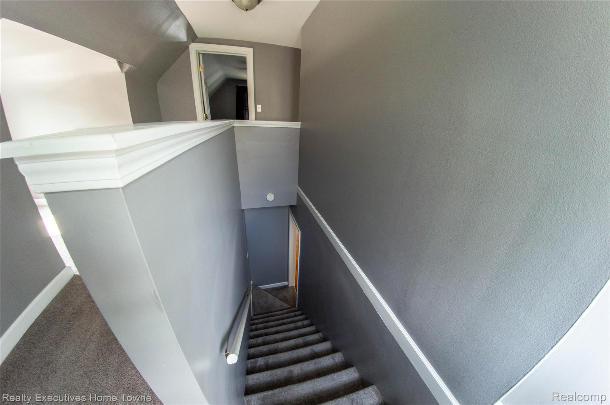 2676 Cumberland Road Berkley, MI 48072 - Photo 25 of 38 Carpeted staircase with light gray walls, white trim, and a metal handrail