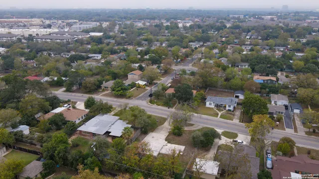 an aerial view of residential houses with city view