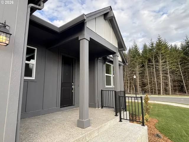 a view of a house with wooden fence and large windows