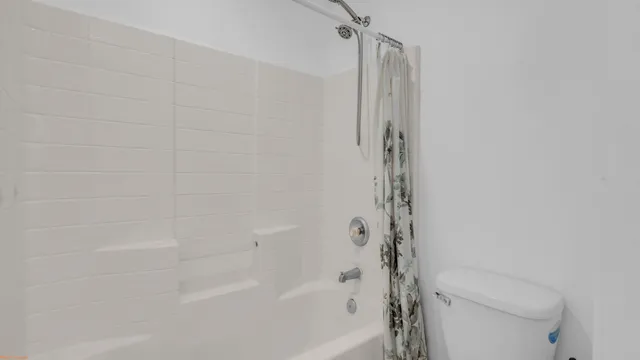 an empty room with a ceiling fan and wooden floor
