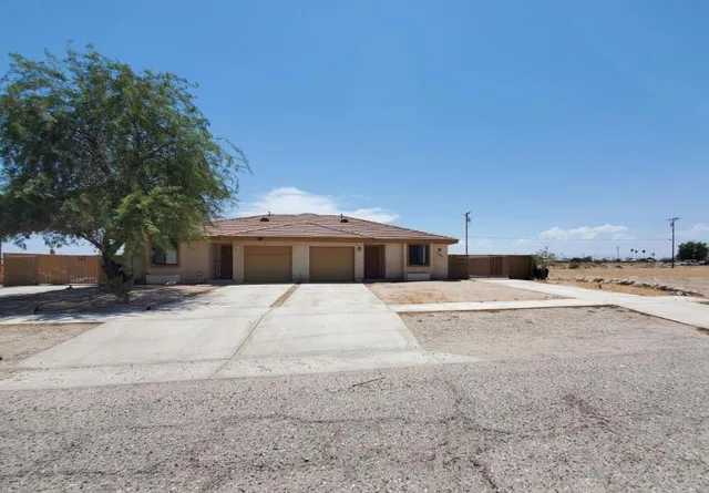 a wooden bench sitting in front of a house