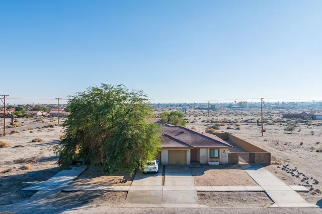 an aerial view of residential houses with outdoor space