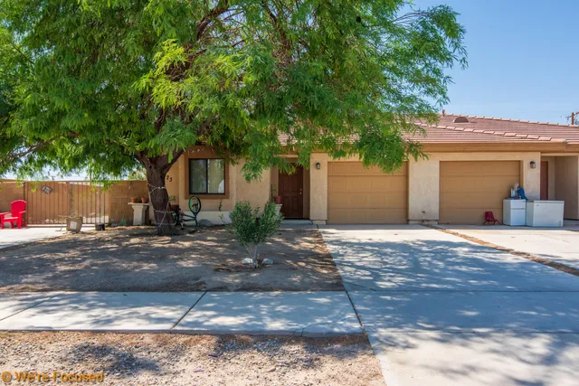 a backyard of a house with table and chairs