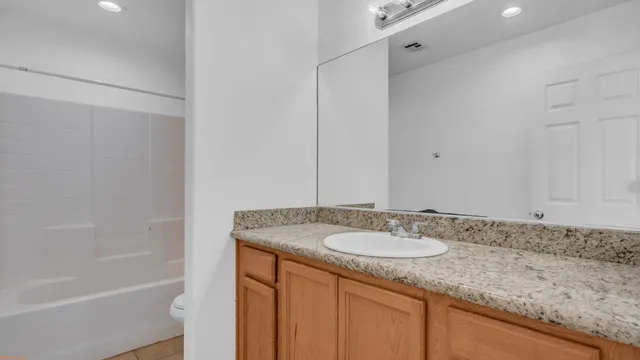 a kitchen with stainless steel appliances granite countertop a refrigerator a sink and a stove