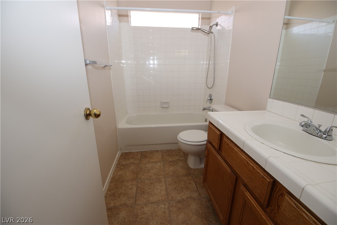 8220 Maplestar Road Las Vegas, NV 89128 - Photo 24 of 29 Functional full bathroom featuring a tub-shower combination, vanity with sink, and tile flooring.