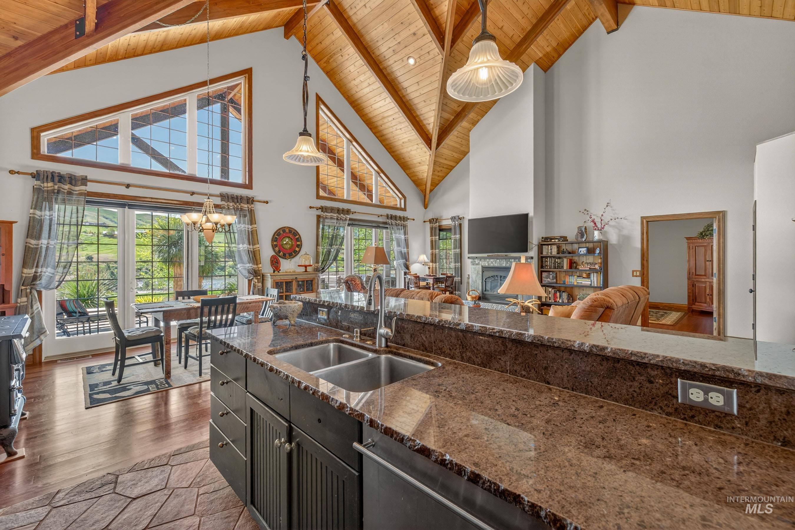 113 Deford Road White Bird, ID 83554 - Photo 12 of 49 Expansive kitchen with a dual basin sink, rich stone countertops, and dark cabinetry