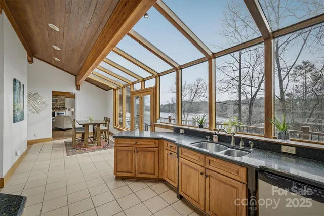 a kitchen with stainless steel appliances granite countertop wooden cabinets a sink and a window