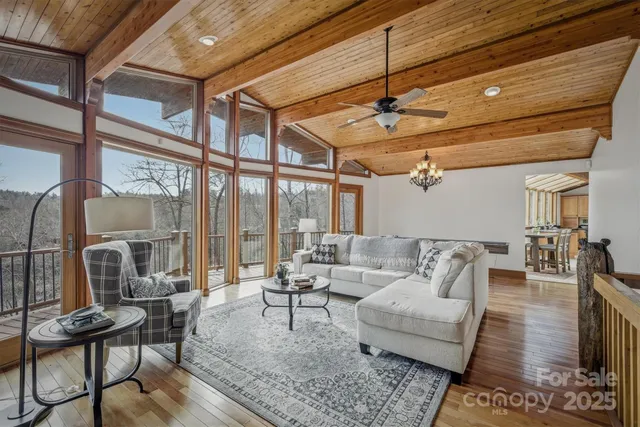 a spacious bedroom with a large bed and a chandelier