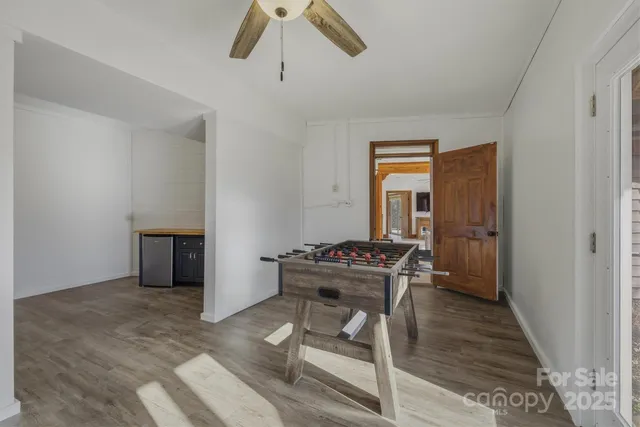 a view of a balcony with chairs and wooden floor