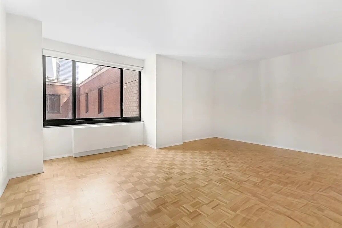 200 Rector Place, Unit 9R Manhattan, NY 10280 - Photo 1 of 12 an empty room with windows