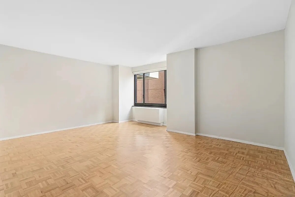 200 Rector Place, Unit 9R Manhattan, NY 10280 - Photo 2 of 12 an empty room with windows and closet