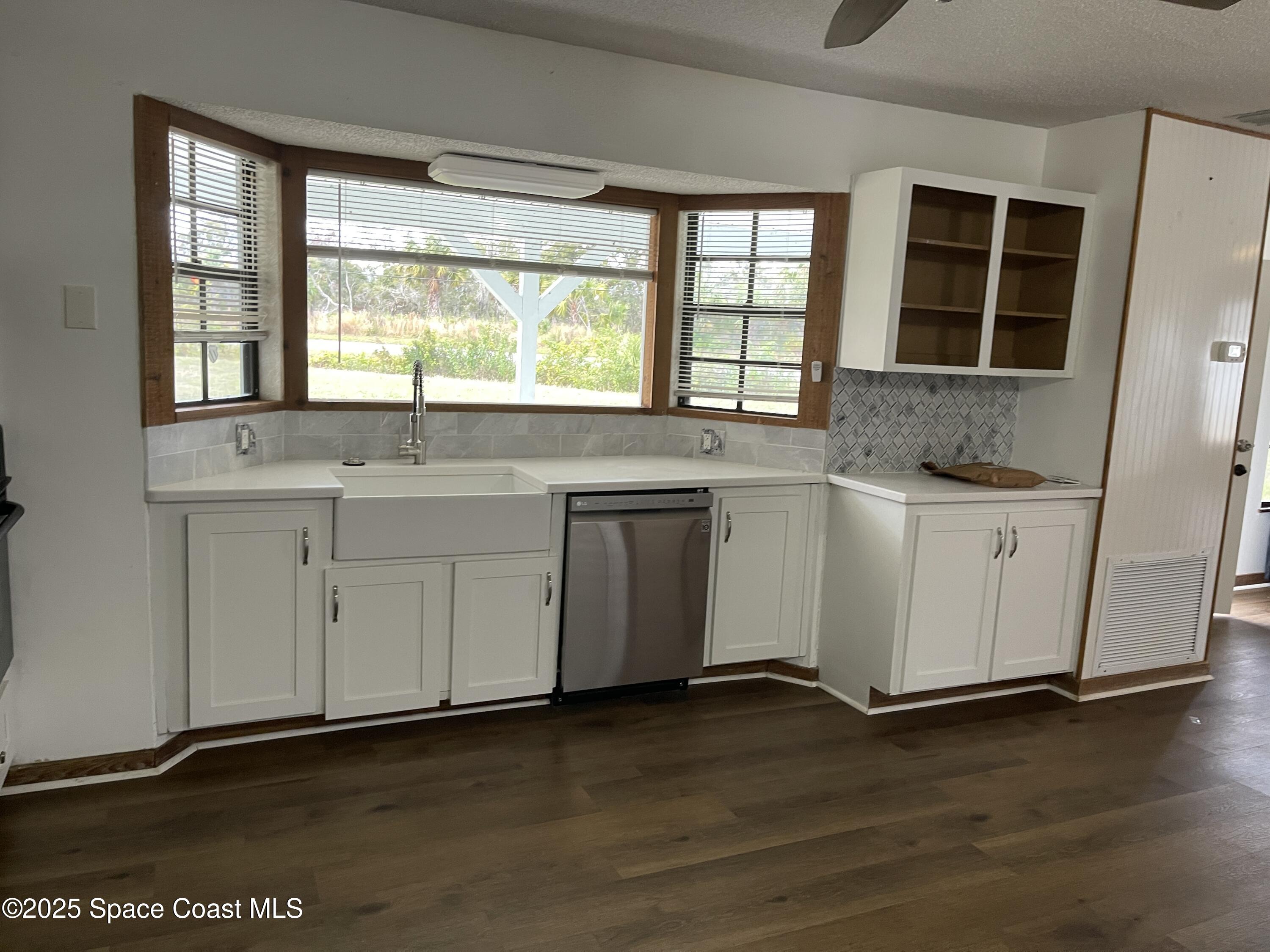 3445 Fox Lake Road Titusville, FL 32780 - Photo 11 of 43 a kitchen with stainless steel appliances granite countertop a sink and a stove top oven