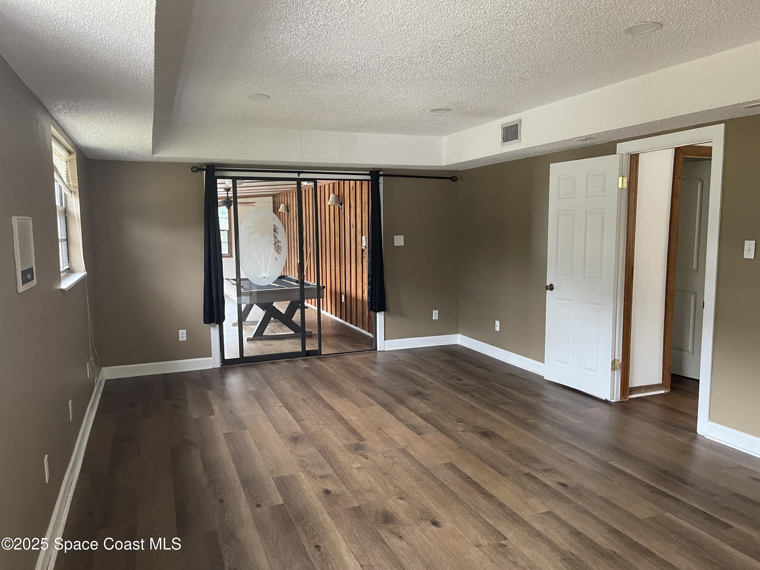3445 Fox Lake Road Titusville, FL 32780 - Photo 12 of 43 a view of a room with wooden floor and furniture