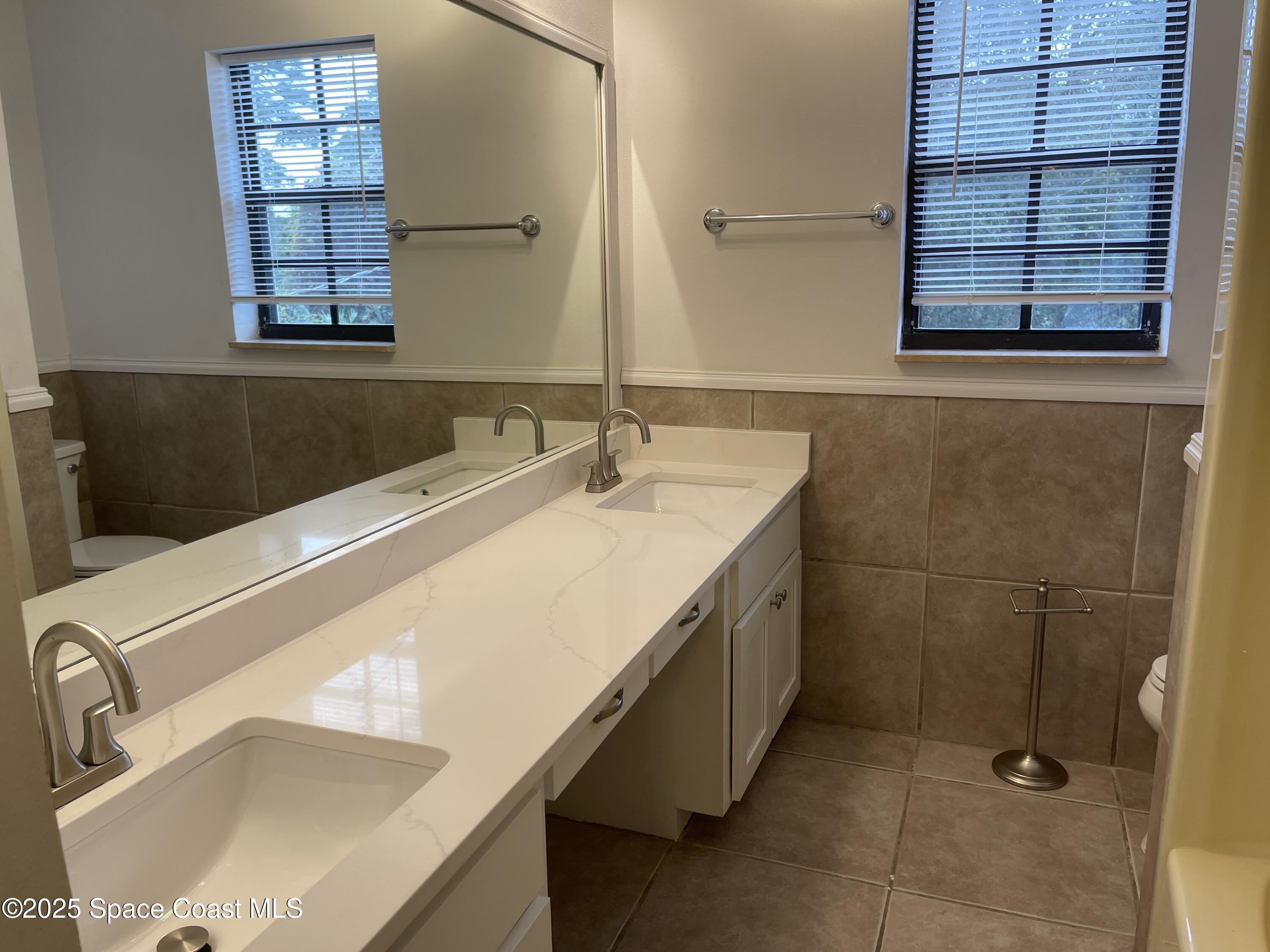 3445 Fox Lake Road Titusville, FL 32780 - Photo 17 of 43 a bathroom with a sink and a bathtub