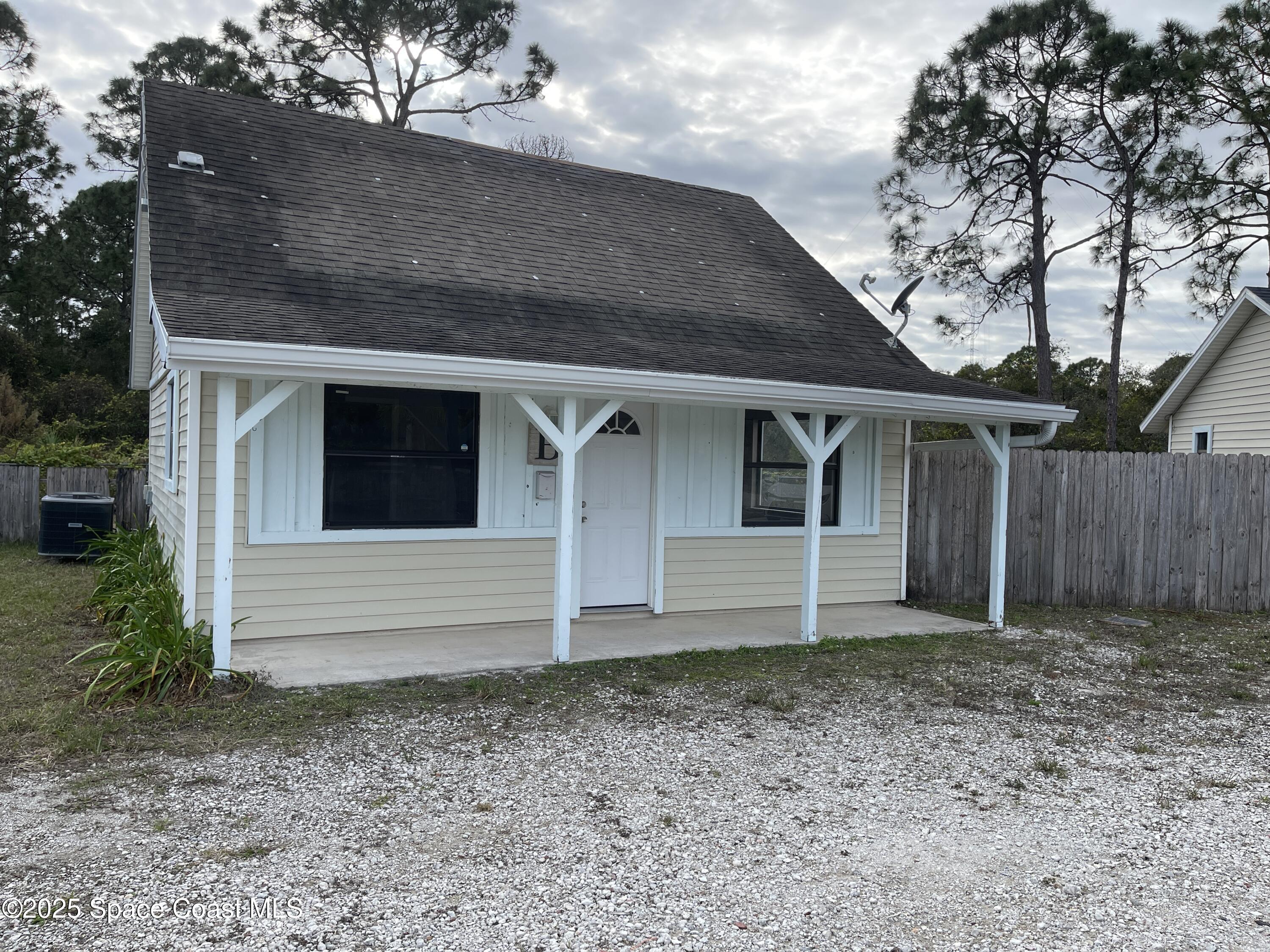 3445 Fox Lake Road Titusville, FL 32780 - Photo 22 of 43 a front view of a house with a garden