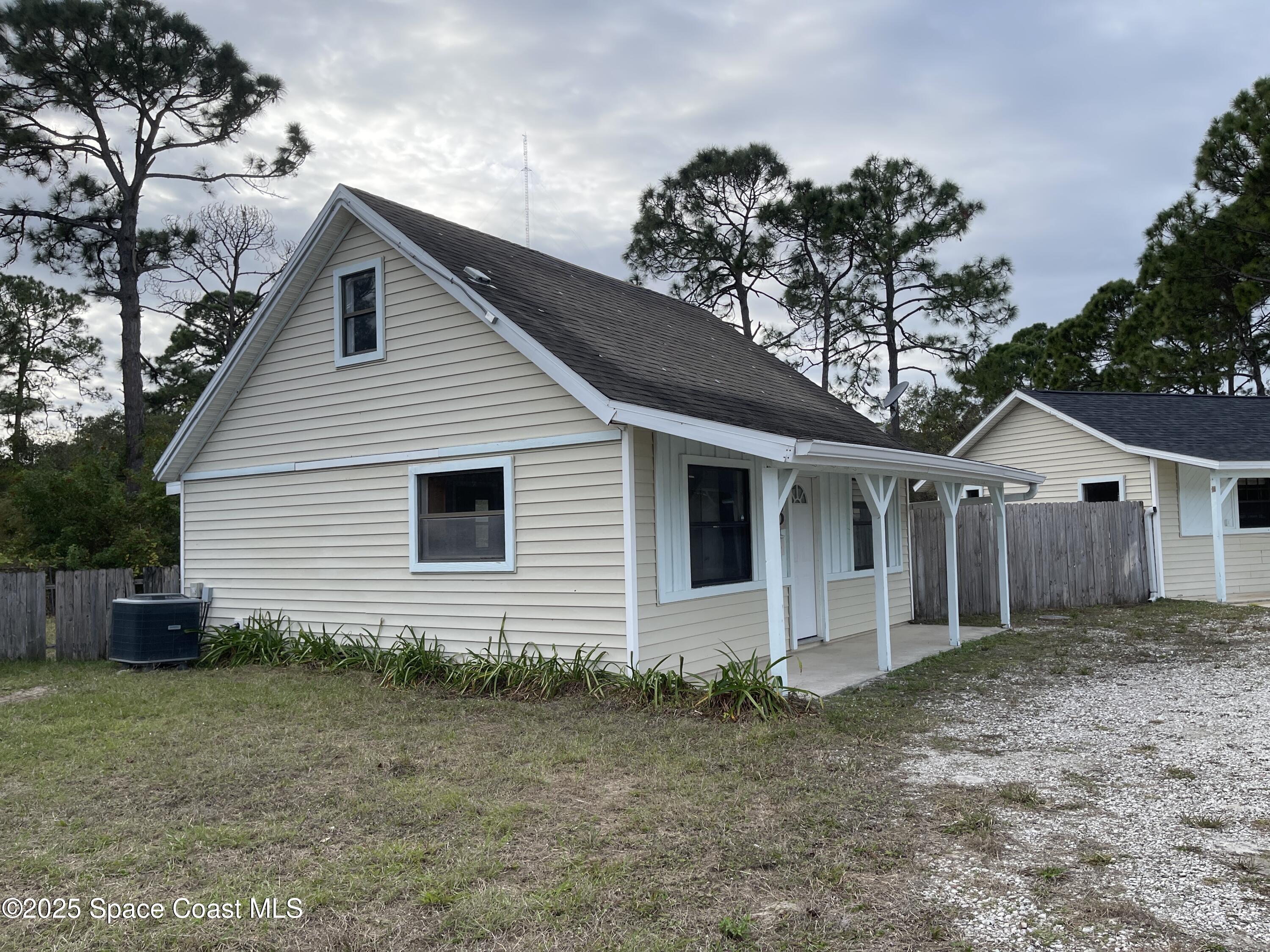 3445 Fox Lake Road Titusville, FL 32780 - Photo 24 of 43 a front view of a house with garden
