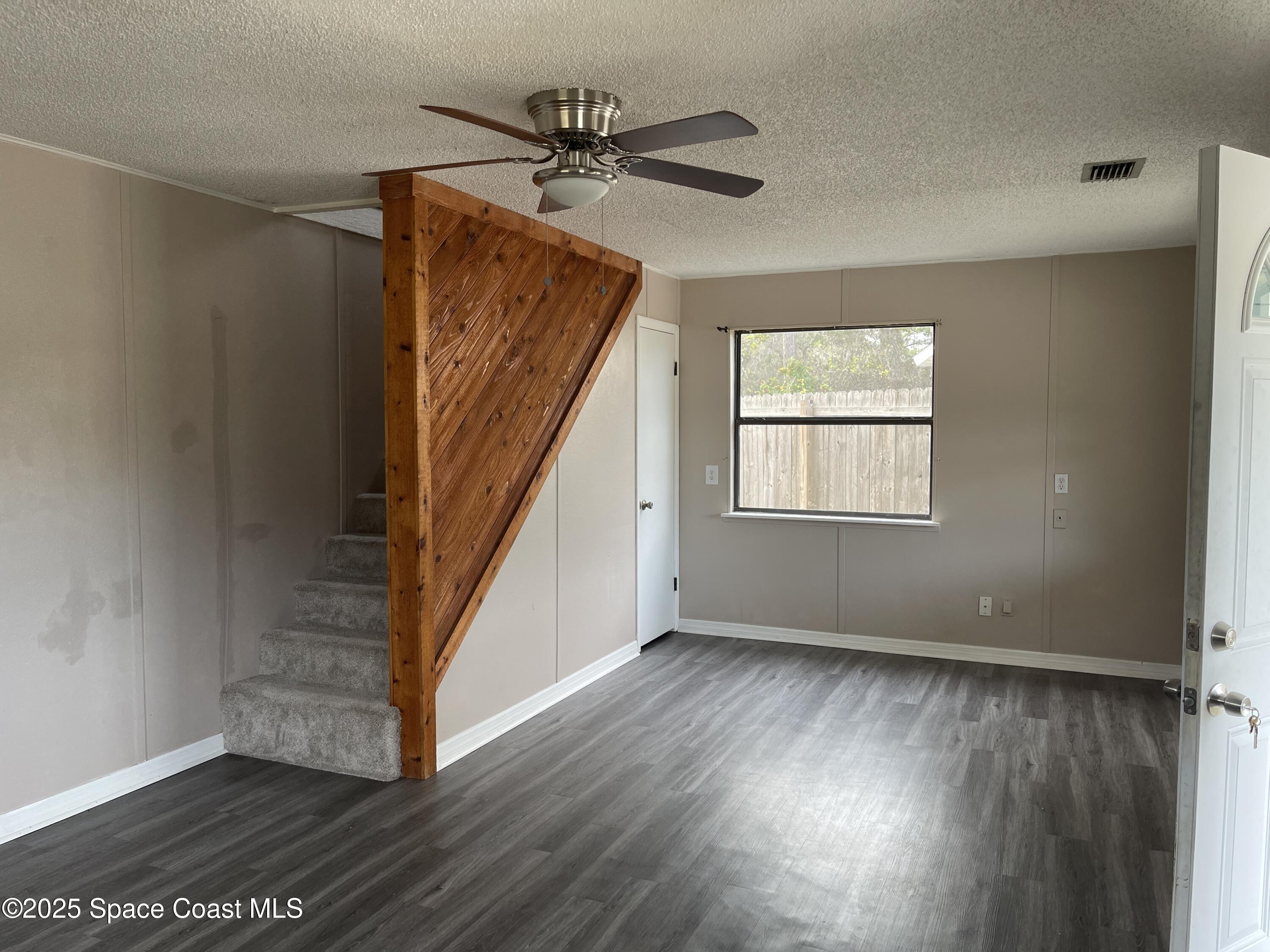3445 Fox Lake Road Titusville, FL 32780 - Photo 27 of 43 a view of an empty room with wooden floor and a window