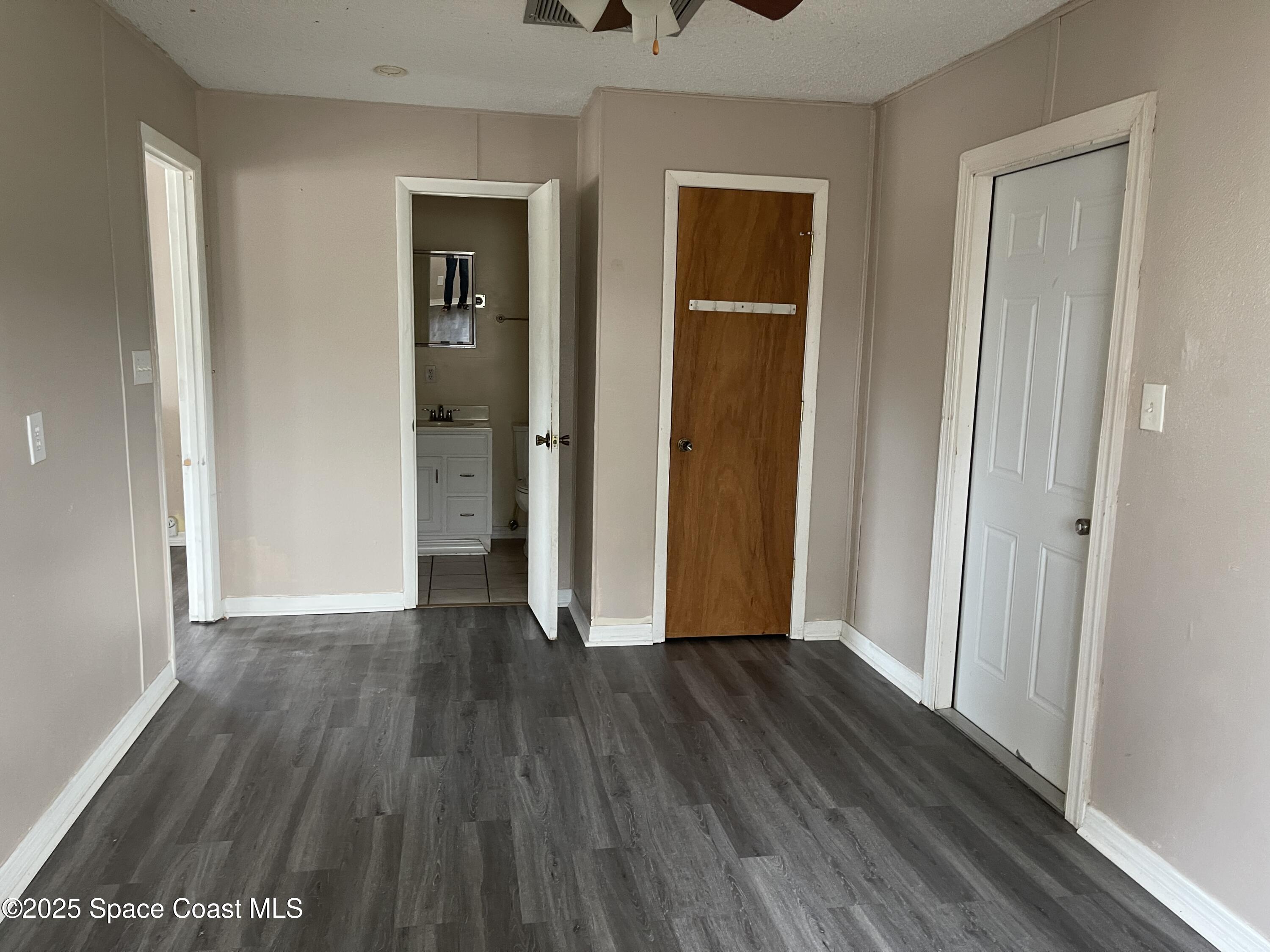 3445 Fox Lake Road Titusville, FL 32780 - Photo 29 of 43 an empty room with wooden floor and closet