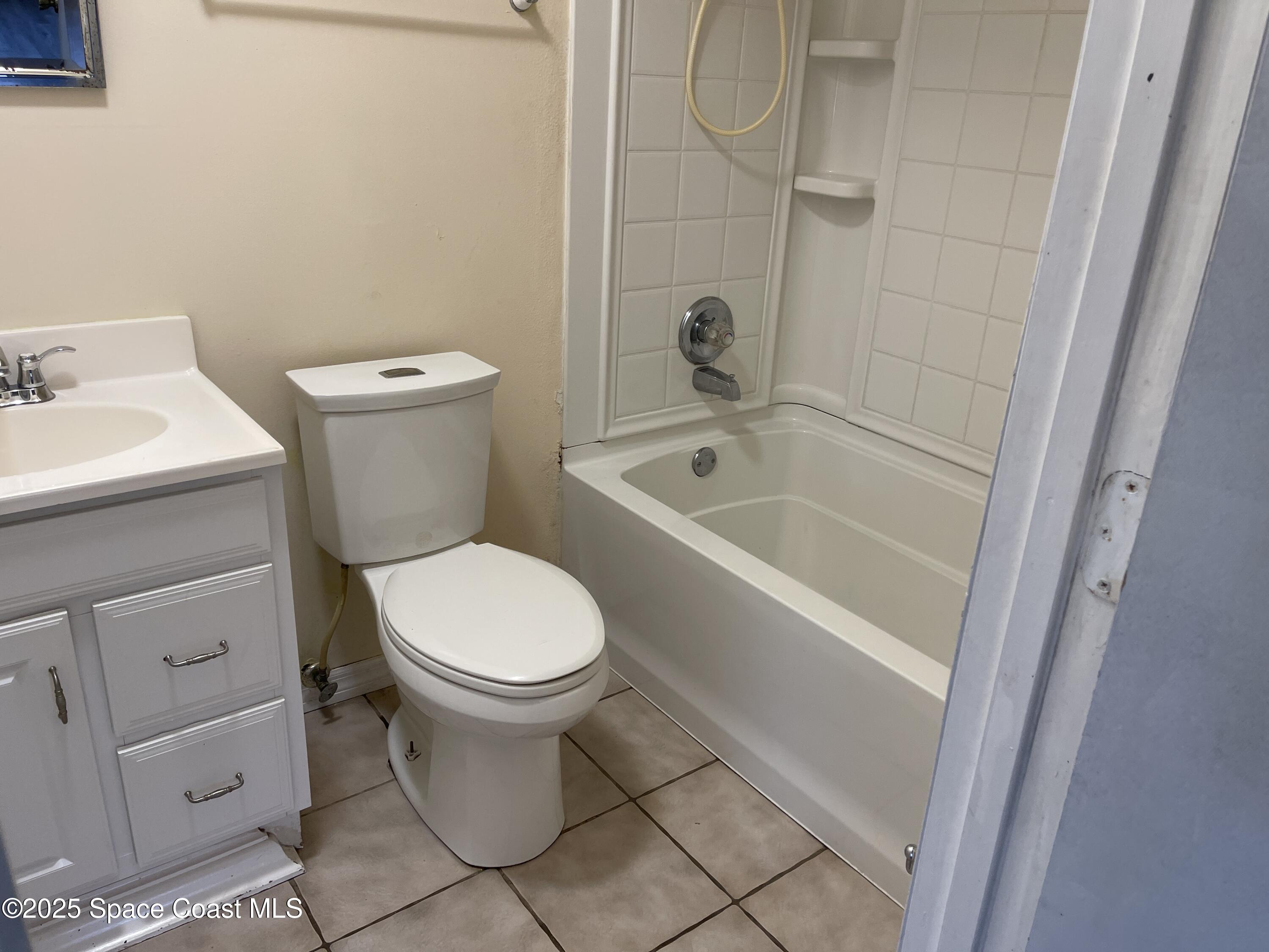3445 Fox Lake Road Titusville, FL 32780 - Photo 30 of 43 a white toilet sitting next to a bath tub