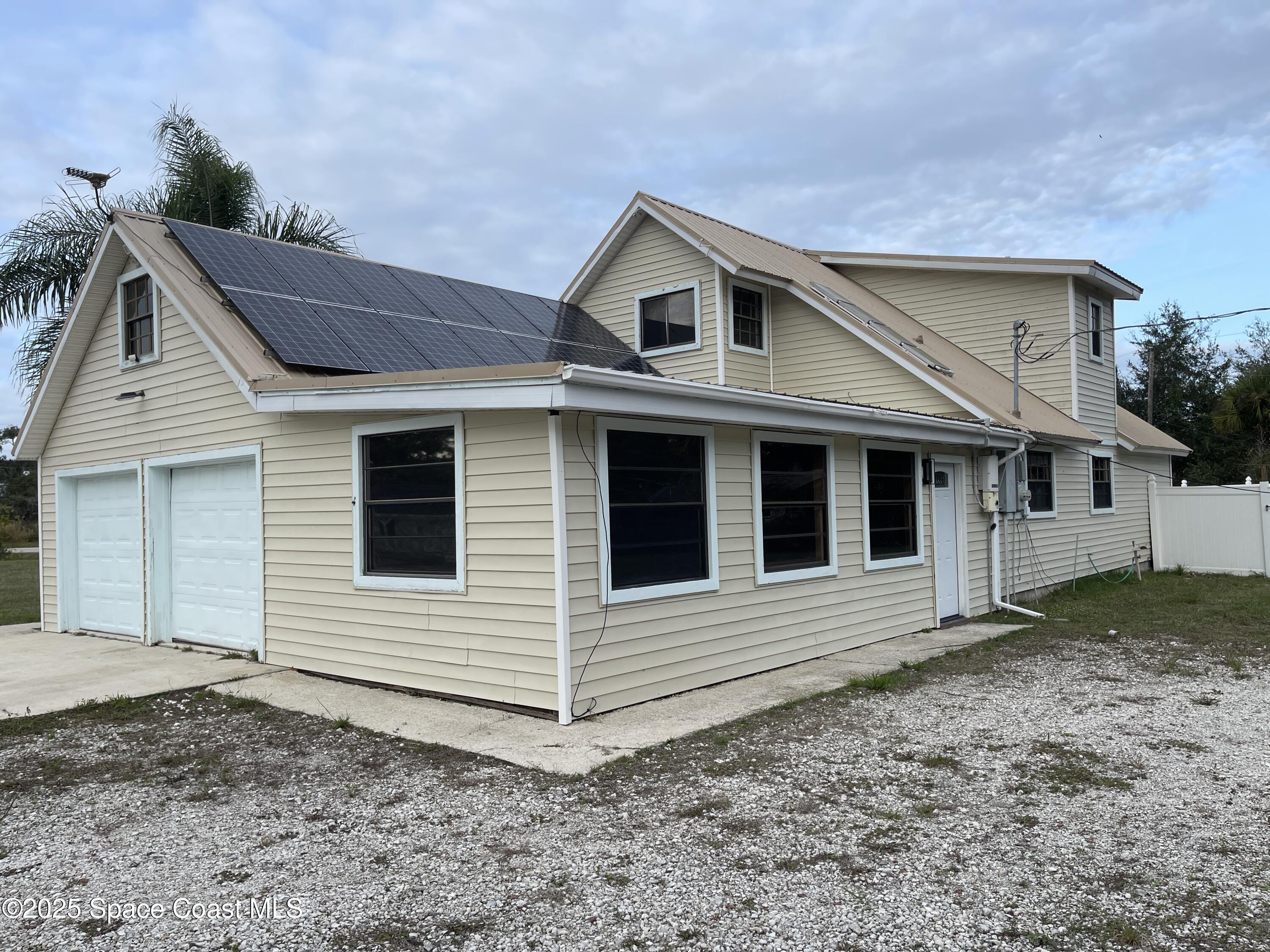 3445 Fox Lake Road Titusville, FL 32780 - Photo 3 of 43 a view of a house with a yard