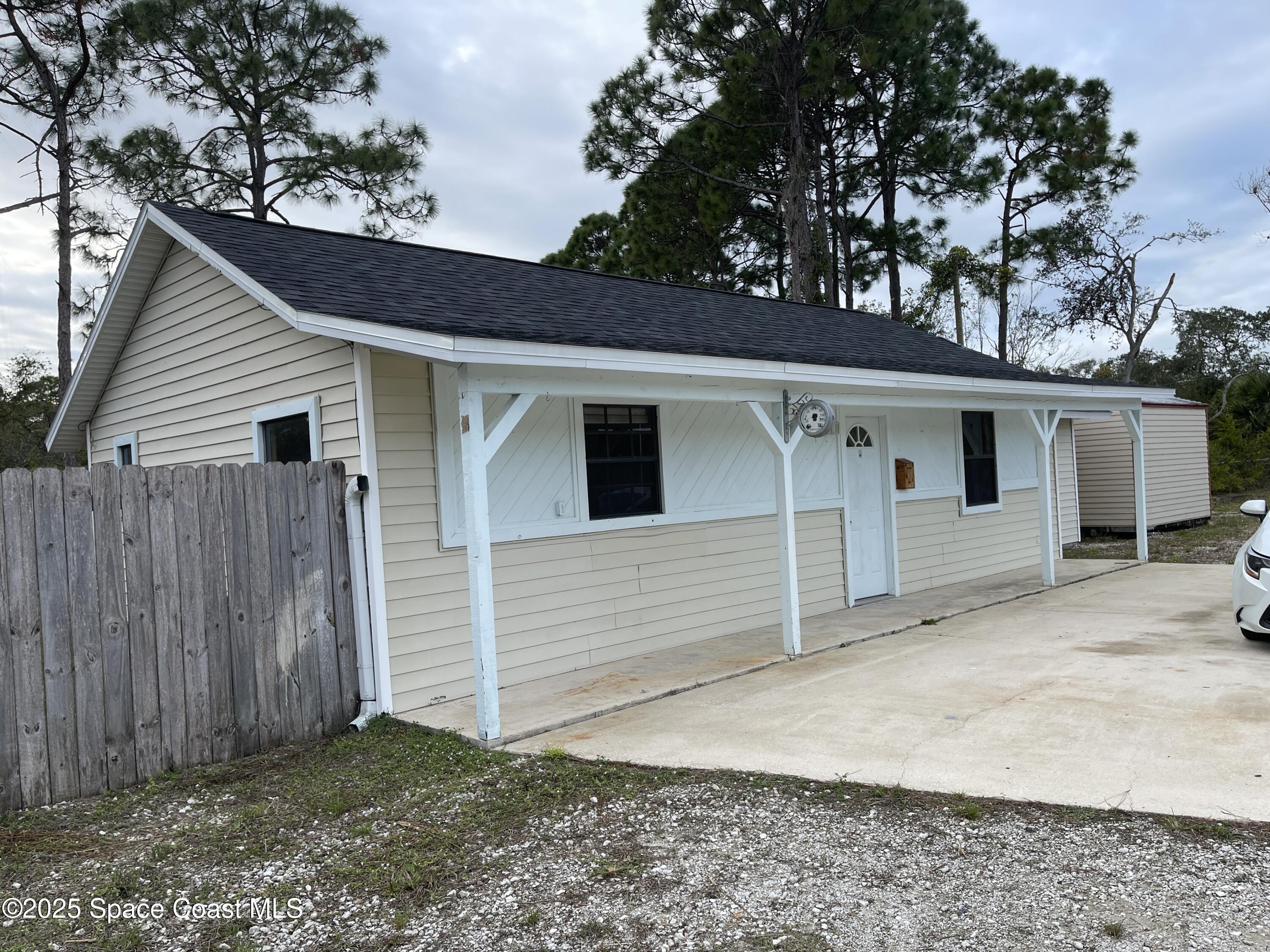 3445 Fox Lake Road Titusville, FL 32780 - Photo 33 of 43 a view of a house with a garage