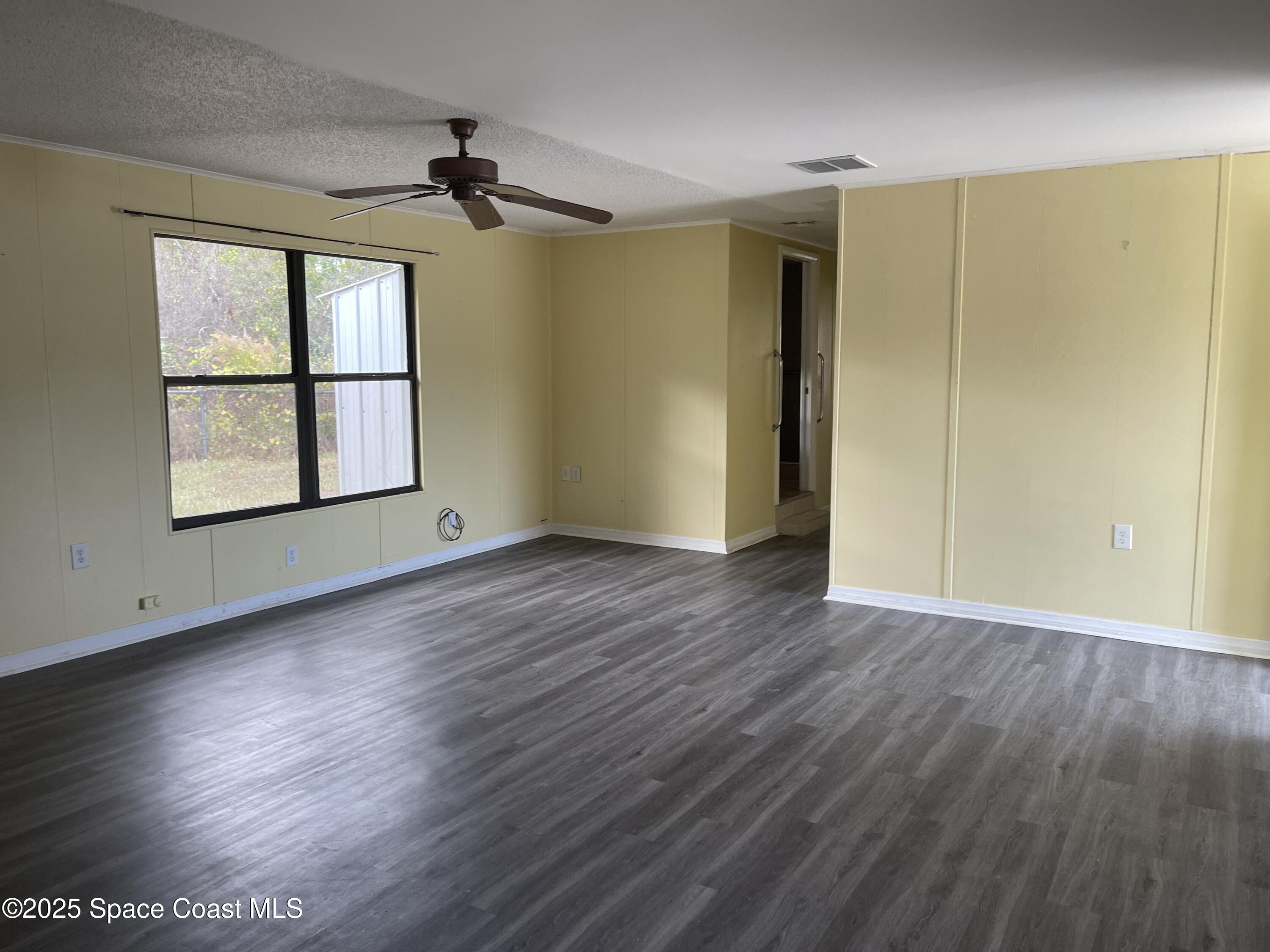 3445 Fox Lake Road Titusville, FL 32780 - Photo 37 of 43 wooden floor in an empty room with a window