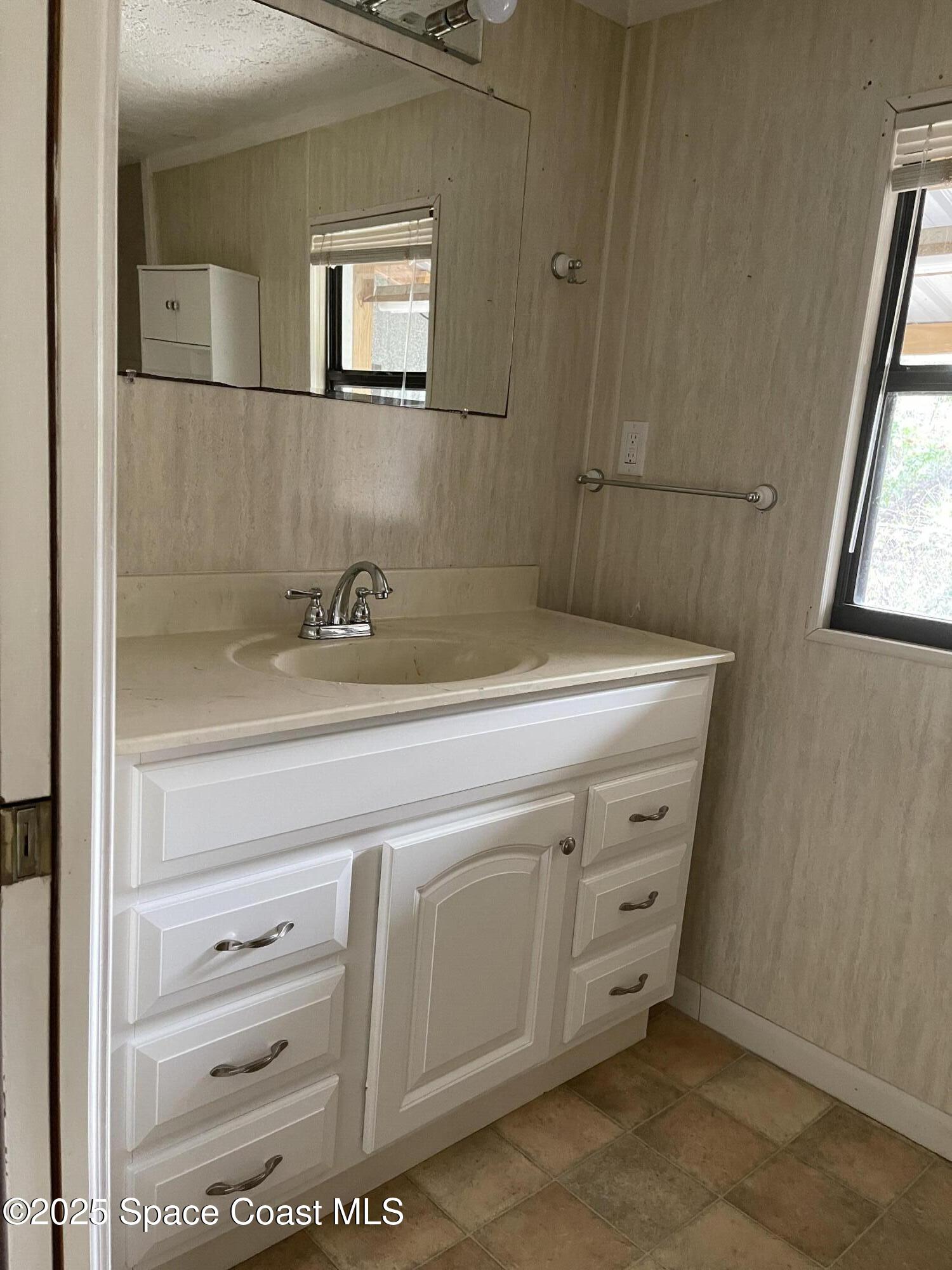 3445 Fox Lake Road Titusville, FL 32780 - Photo 38 of 43 a close view of a sink a mirror and a window