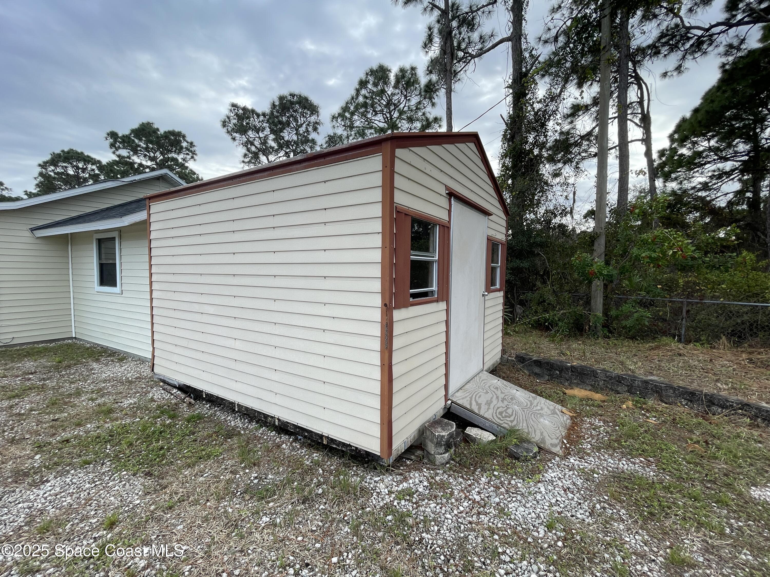 3445 Fox Lake Road Titusville, FL 32780 - Photo 42 of 43 a view of a house with a yard