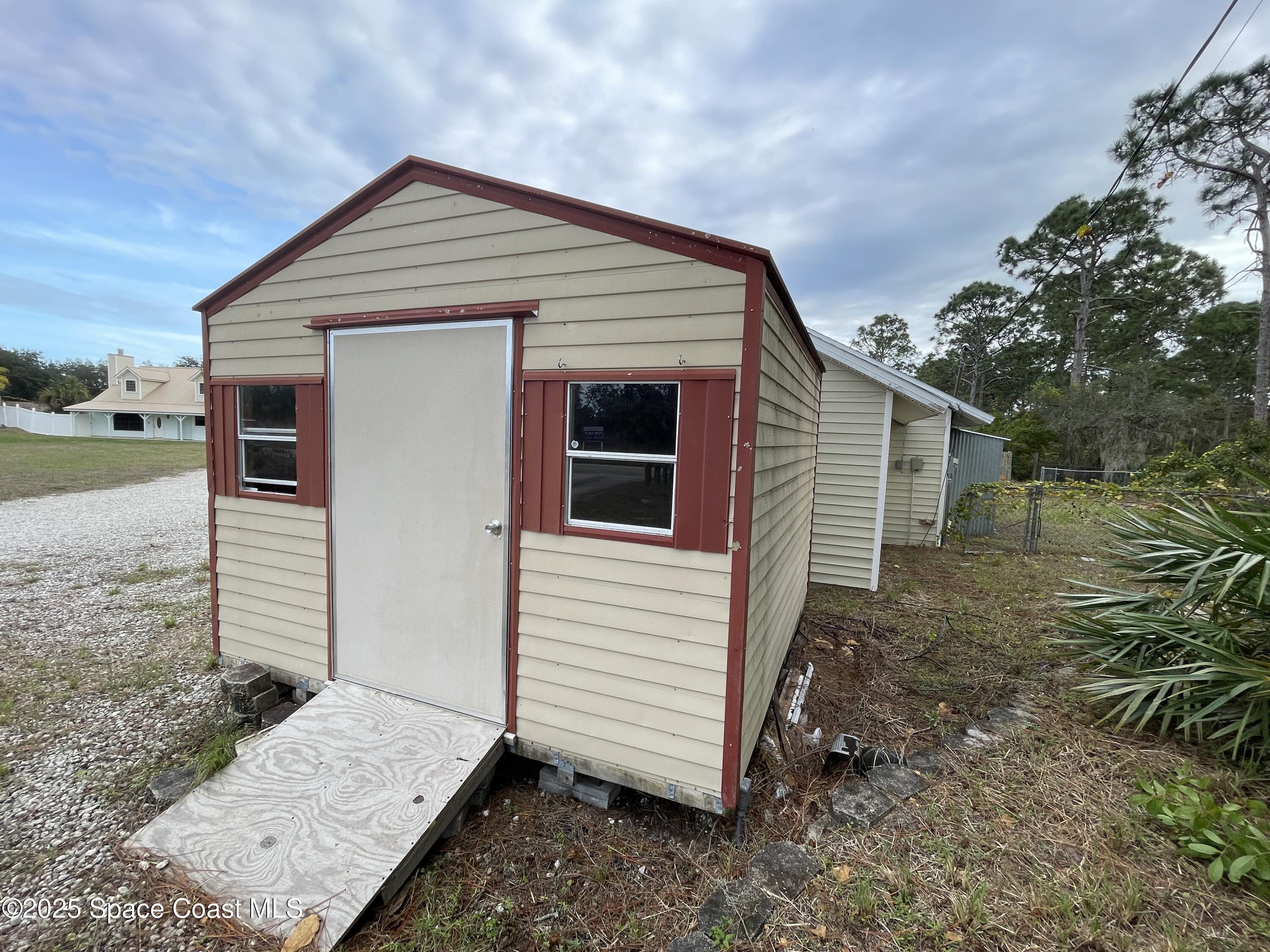 3445 Fox Lake Road Titusville, FL 32780 - Photo 43 of 43 a front view of a house with a yard