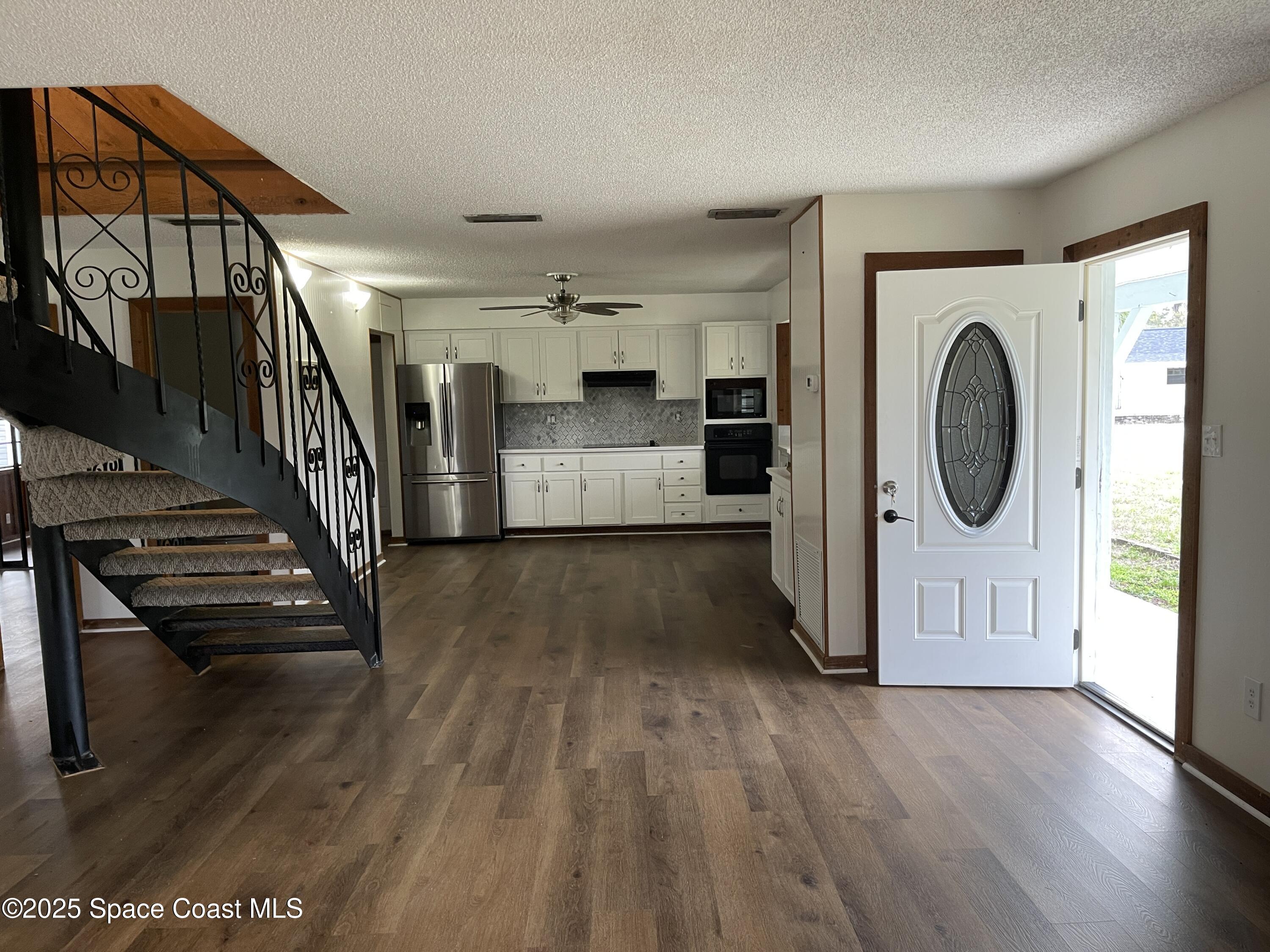 3445 Fox Lake Road Titusville, FL 32780 - Photo 9 of 43 a view of a hallway with wooden floor and entryway