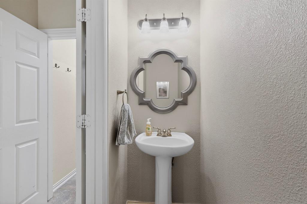 4004 White Porch Road Plano, TX 75024 - Photo 34 of 40 a bathroom with a sink and a mirror