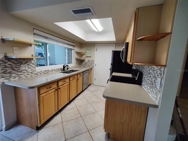 a view of a kitchen with a sink and a window
