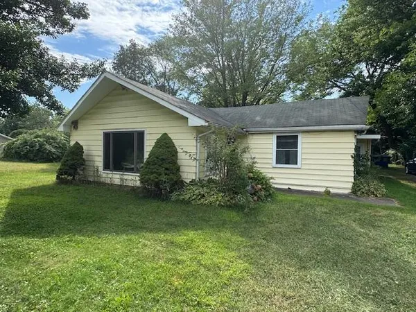 a front view of house with yard and green space