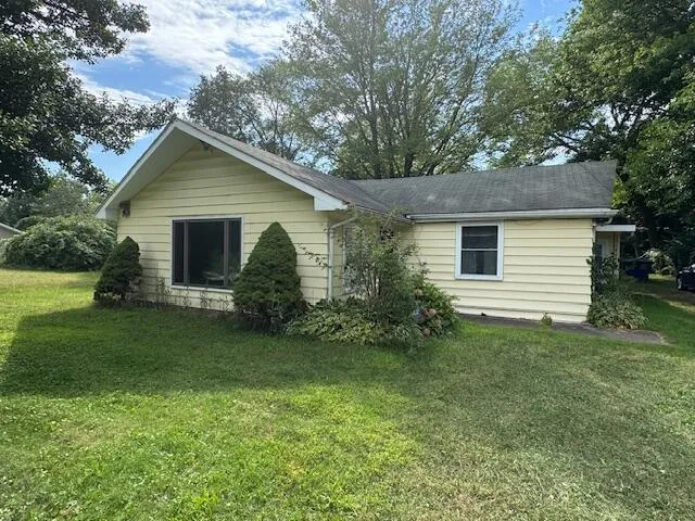 a front view of house with yard and green space