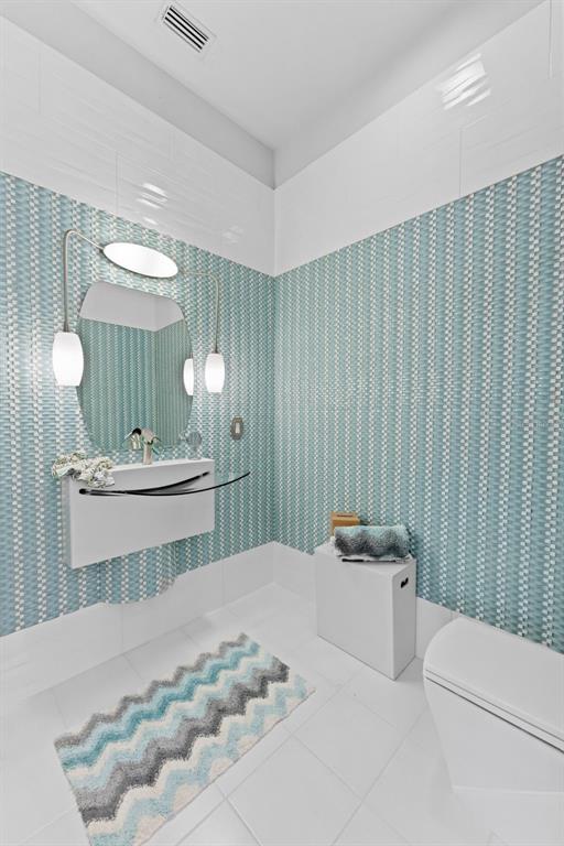 4150 Snail Island Court Boca Grande, FL 33921 - Photo 25 of 98 a bathroom with a double vanity sink mirror and toilet