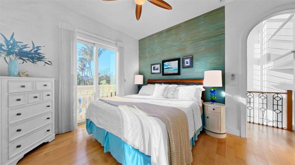 4150 Snail Island Court Boca Grande, FL 33921 - Photo 27 of 98 a bedroom with a bed and a chandelier