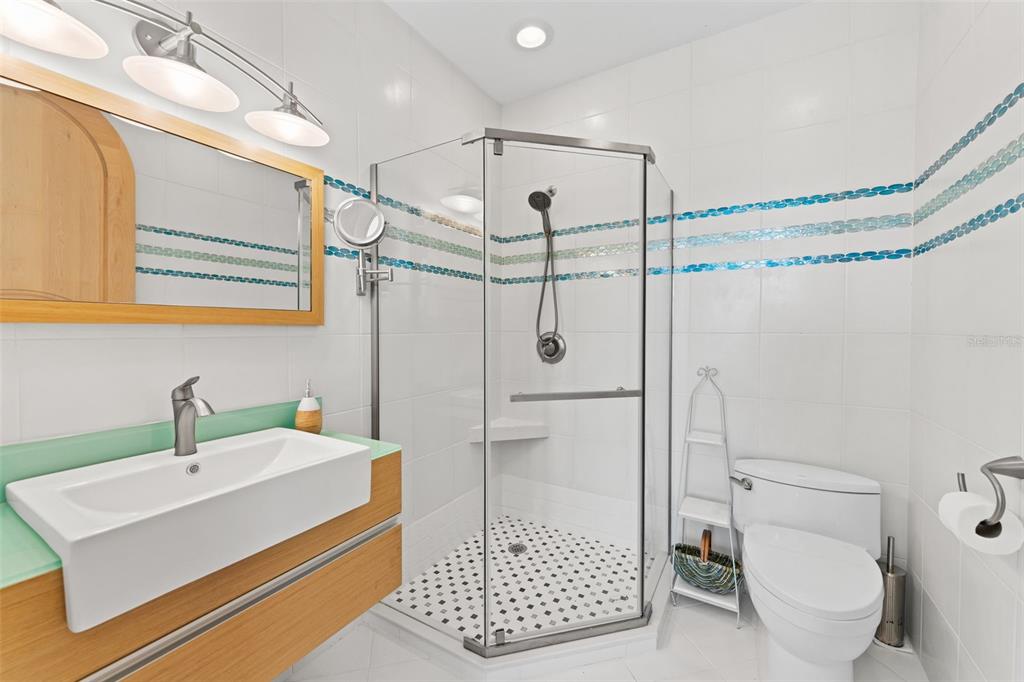 4150 Snail Island Court Boca Grande, FL 33921 - Photo 30 of 98 a bathroom with a sink a toilet and shower