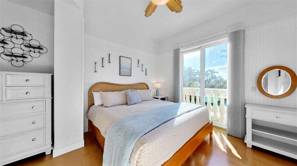 4150 Snail Island Court Boca Grande, FL 33921 - Photo 32 of 98 a bedroom with a bed and a chandelier