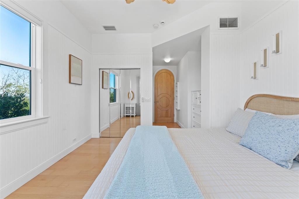 4150 Snail Island Court Boca Grande, FL 33921 - Photo 33 of 98 a bedroom with a bed and a chandelier