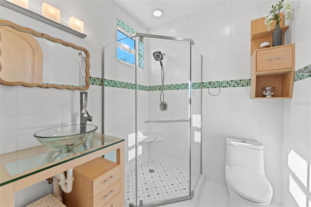 4150 Snail Island Court Boca Grande, FL 33921 - Photo 37 of 98 a bathroom with a granite countertop sink a toilet and a mirror