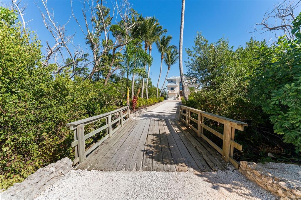 4150 Snail Island Court Boca Grande, FL 33921 - Photo 5 of 98 a view of a balcony with wooden floor and plants