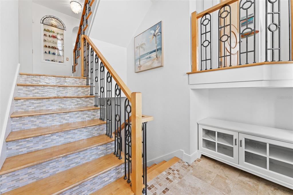 4150 Snail Island Court Boca Grande, FL 33921 - Photo 61 of 98 a view of staircase with lots of frames on wall and a window