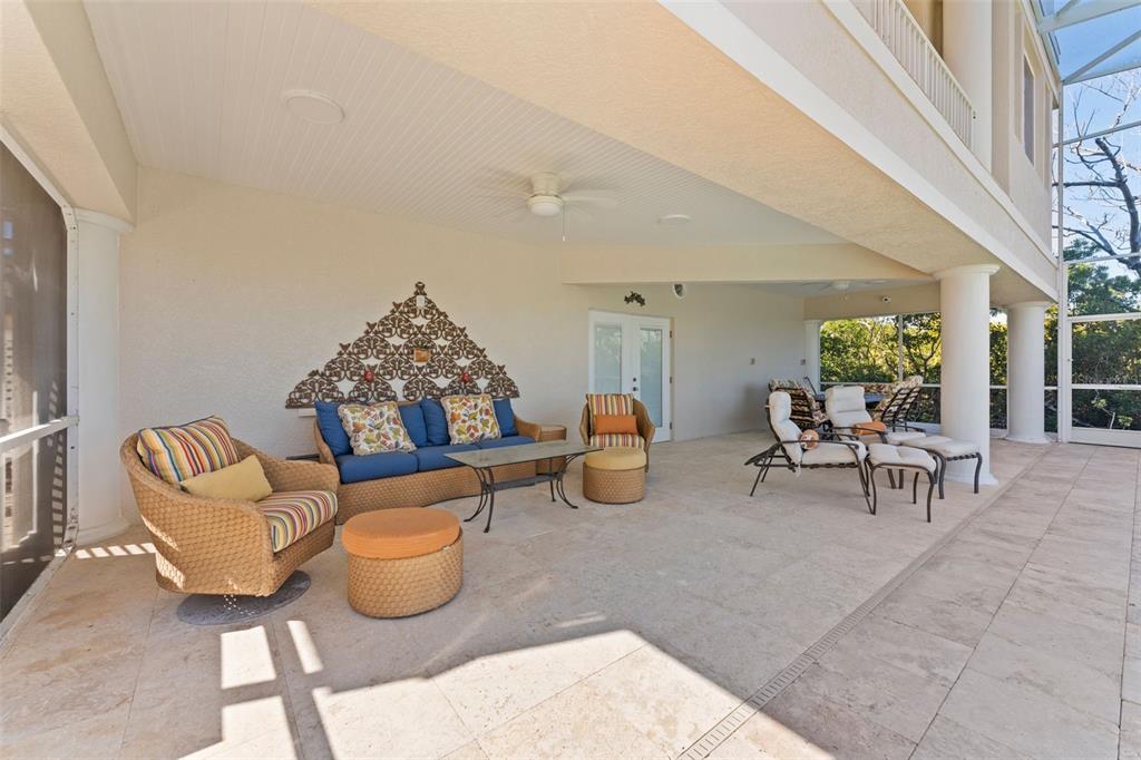 4150 Snail Island Court Boca Grande, FL 33921 - Photo 68 of 98 a living room with furniture and a chandelier