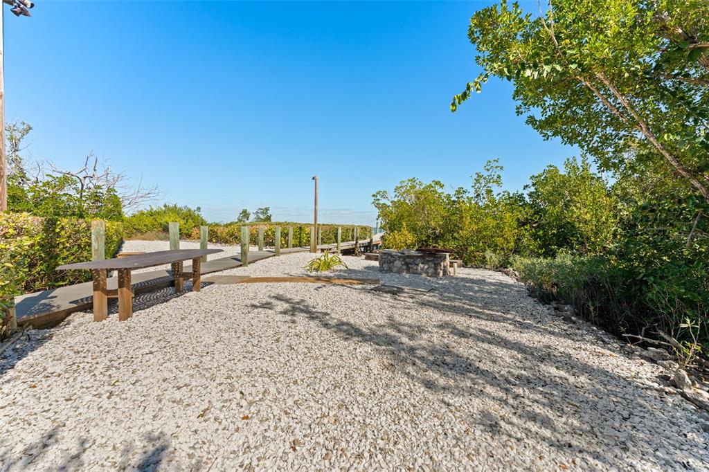 4150 Snail Island Court Boca Grande, FL 33921 - Photo 74 of 98 a view of a backyard with sitting area
