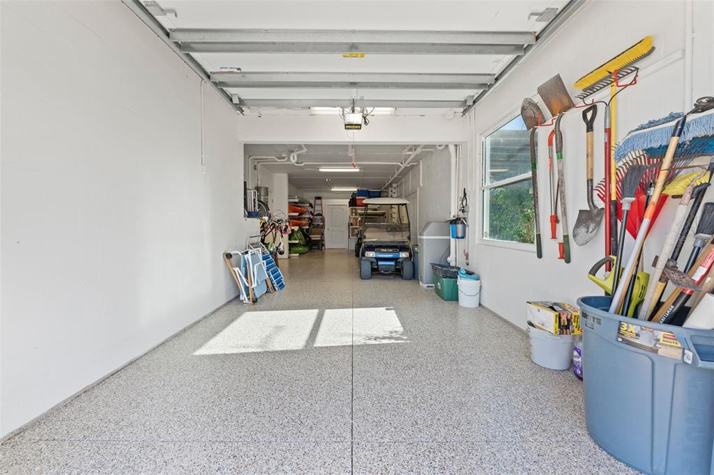 4150 Snail Island Court Boca Grande, FL 33921 - Photo 82 of 98 a living room with a large window and a book shelf