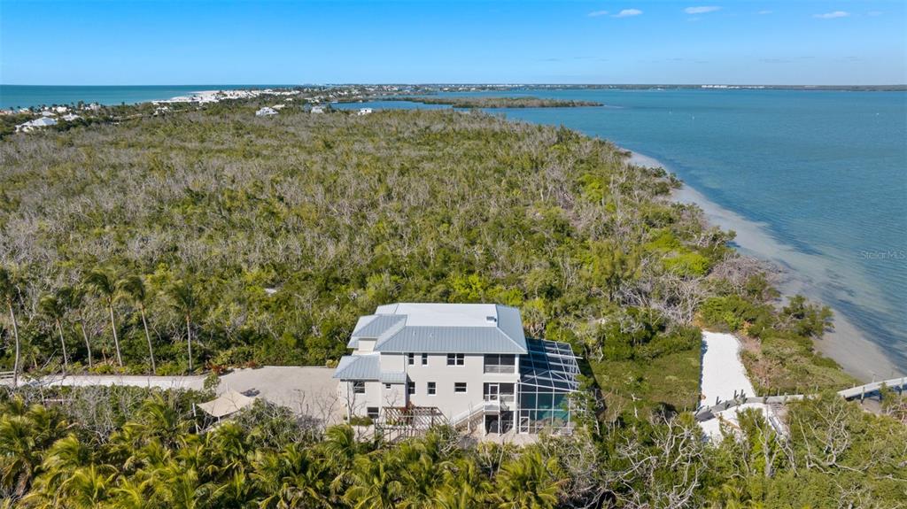 4150 Snail Island Court Boca Grande, FL 33921 - Photo 92 of 98 an aerial view of a house with a lake view