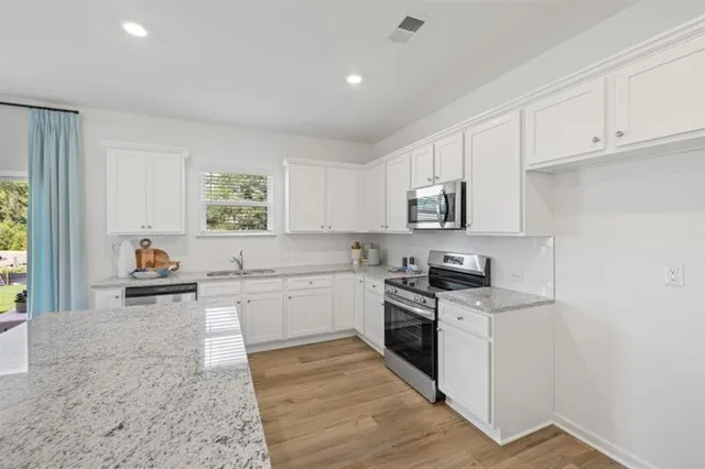 a kitchen with a sink stove and cabinets