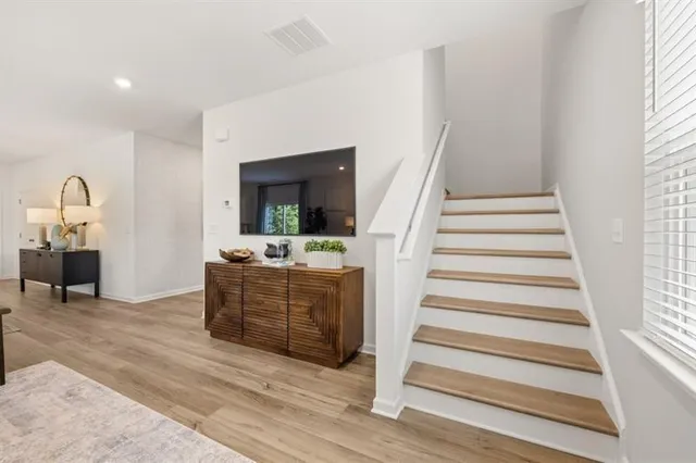 a view of a hallway with chairs and a bathroom