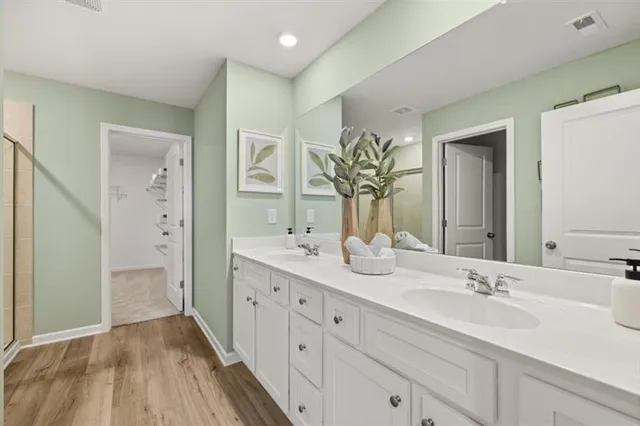a en suite bathroom with a double sink and mirror